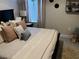 Bedroom with a queen-size bed and neutral-toned bedding and decor at 16383 S Port Harbor Blvd, Port Charlotte, FL 33953