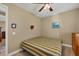 Guest bedroom with striped bedding and wood dresser at 2 Marker Rd, Rotonda West, FL 33947