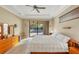 Bright main bedroom with pool access and wooden furniture at 2 Marker Rd, Rotonda West, FL 33947