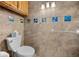 Small bathroom with sea-themed tile and a toilet at 445 Stewart St, Englewood, FL 34223