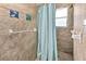 Shower with light blue curtain and tiled walls at 445 Stewart St, Englewood, FL 34223