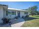 House exterior with blue door, stone pathway and manicured landscaping at 445 Stewart St, Englewood, FL 34223