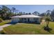 Single story home with metal roof, spacious yard and palm trees at 445 Stewart St, Englewood, FL 34223