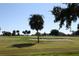 Landscaped golf course with palm trees and sand traps at 445 Stewart St, Englewood, FL 34223