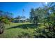 Ranch-style home with lush lawn and flagpole at 445 Stewart St, Englewood, FL 34223