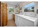 Laundry room with washer, dryer, and wooden cabinets at 445 Stewart St, Englewood, FL 34223