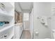 Updated bathroom with white vanity, large mirror, and a shower/tub combo at 5826 Harrison Rd, Venice, FL 34293