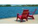 Relaxing dockside with red Adirondack chairs at 5826 Harrison Rd, Venice, FL 34293