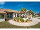 House exterior with lush landscaping and a paved walkway at 5826 Harrison Rd, Venice, FL 34293