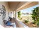 Covered porch with wicker chairs and peaceful neighborhood view at 5826 Harrison Rd, Venice, FL 34293