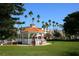 White gazebo with red roof in a park setting at 5826 Harrison Rd, Venice, FL 34293