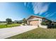 House exterior with a two-car garage and well-maintained lawn at 5826 Harrison Rd, Venice, FL 34293