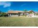 Front view of a house with a landscaped yard and attached garage at 5826 Harrison Rd, Venice, FL 34293