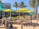 Outdoor patio seating with colorful umbrellas and a lively ambiance at 5826 Harrison Rd, Venice, FL 34293