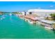 Aerial view of a vibrant waterfront area with numerous boats and a restaurant at 5826 Harrison Rd, Venice, FL 34293