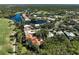 Picturesque aerial view of homes nestled around a scenic lake and lush green golf course at 3117 Silkwood Ln, Port Charlotte, FL 33953