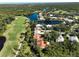 Stunning aerial view of golf course community with lush landscaping and beautiful homes along water feature at 3117 Silkwood Ln, Port Charlotte, FL 33953