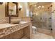Elegant bathroom featuring a stone sink, decorative tiling, and a glass-enclosed shower at 3117 Silkwood Ln, Port Charlotte, FL 33953