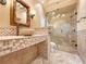 Elegant bathroom featuring a stone sink, decorative tiling, and a glass-enclosed shower at 3117 Silkwood Ln, Port Charlotte, FL 33953