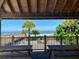 Picturesque beach view from a shaded wooden pavilion with picnic tables and a clear blue sky at 3117 Silkwood Ln, Port Charlotte, FL 33953