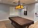 Well-lit billiards room featuring a pool table with a brown cover and cue rack at 3117 Silkwood Ln, Port Charlotte, FL 33953