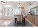 Charming dining room with elegant chandelier, stylish furniture, and plenty of natural light at 3117 Silkwood Ln, Port Charlotte, FL 33953