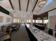 Upscale dining area with elegant chandeliers, large windows, and ample seating for guests with bar at 3117 Silkwood Ln, Port Charlotte, FL 33953