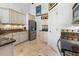 Well-lit kitchen featuring stone countertops, stainless steel appliances, and ample cabinet space at 3117 Silkwood Ln, Port Charlotte, FL 33953