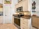 Well-lit kitchen showcasing stainless steel oven, microwave, granite countertops, and beige cabinetry at 3117 Silkwood Ln, Port Charlotte, FL 33953