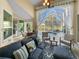 Relaxing screened lanai with comfortable seating, ceiling fan, and view of the pool and backyard at 3117 Silkwood Ln, Port Charlotte, FL 33953