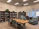 Inviting community library with bookshelves and a large table with chairs for reading and studying at 3117 Silkwood Ln, Port Charlotte, FL 33953