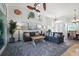 Open living room featuring comfortable sofas, decor, and access to the dining area at 3117 Silkwood Ln, Port Charlotte, FL 33953
