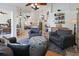 Open living area with cozy armchairs, decorative ottoman, high ceilings, and a view into the kitchen at 3117 Silkwood Ln, Port Charlotte, FL 33953