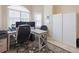 Bright home office featuring a desk, dual monitors, rolling chair, and closet for ample storage at 3117 Silkwood Ln, Port Charlotte, FL 33953