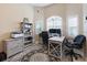 Home office with a large desk, dual monitors, rolling chair, shelving unit, and area rug at 3117 Silkwood Ln, Port Charlotte, FL 33953