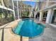 Beautiful kidney-shaped pool in a screened enclosure with a brick paver deck at 3117 Silkwood Ln, Port Charlotte, FL 33953