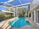 Screened pool area with a beautiful backyard view, great for relaxing and entertaining at 3117 Silkwood Ln, Port Charlotte, FL 33953