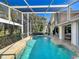 Beautiful screened pool area with lush landscaping and a relaxing spa at 3117 Silkwood Ln, Port Charlotte, FL 33953