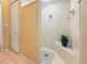 Bathroom shower stall featuring white tile, a corner seat, and a potted plant for a clean look at 3117 Silkwood Ln, Port Charlotte, FL 33953