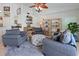 Cozy sitting area with armchairs, ottoman, and shelving, creating a comfortable living space at 3117 Silkwood Ln, Port Charlotte, FL 33953