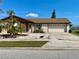 Ranch-style home with stone accents and a spacious driveway at 6358 Granger Rd, Port Charlotte, FL 33981