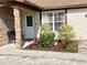 Landscaped entryway with stone pillars and a white front door at 6358 Granger Rd, Port Charlotte, FL 33981