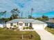 Single-story house with attached garage and landscaping at 10430 Chablis Ave, Englewood, FL 34224