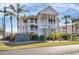 Two-story building exterior, featuring light-colored siding and landscaping at 11000 Placida Rd # 1603, Placida, FL 33946