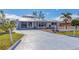 Front view of a single-story home with a metal roof and white picket fence at 2075 Pennsylvania Ave, Englewood, FL 34224