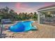 Freeform swimming pool with a paved patio and lounge chairs at 2251 Meetze St, Port Charlotte, FL 33953