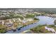 Aerial view of canal-front home in a residential neighborhood at 4106 Library St, Port Charlotte, FL 33948