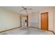 Bedroom with ceiling fan, built-in shelves, and carpeted floors at 4106 Library St, Port Charlotte, FL 33948