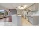 Kitchen with grey cabinets, tile floors and an island at 4106 Library St, Port Charlotte, FL 33948