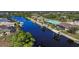 Aerial view of waterfront homes with boat docks and lush landscaping at 9567 Honeymoon Dr, Port Charlotte, FL 33981